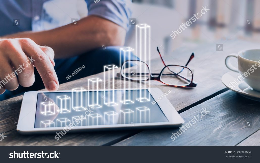 stock-photo-businessman-analyzing-growing-d-ar-chart-floating-above-digital-tablet-computer-screen-showing-734391004
